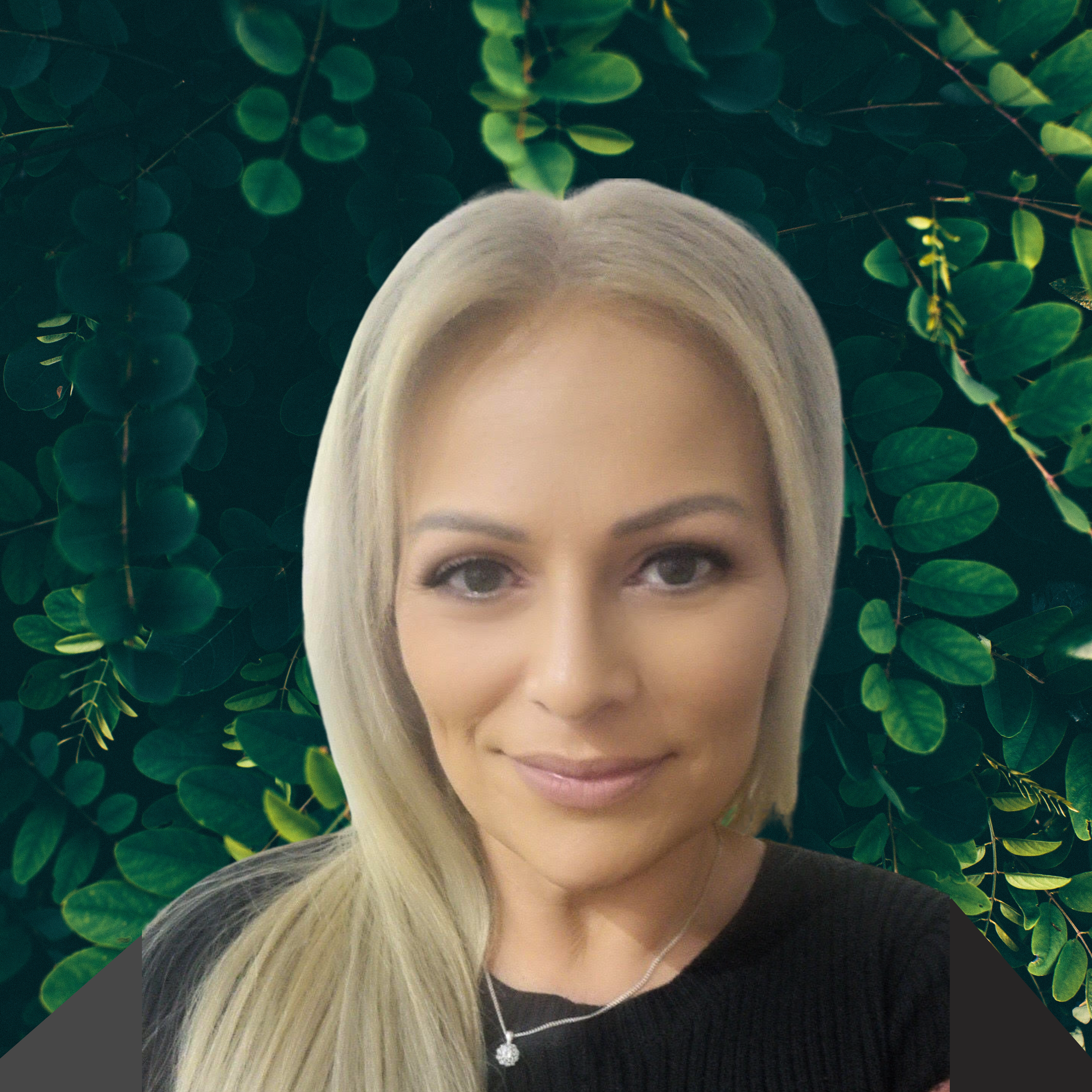 Photo of Mel, a woman with blonde hair. She is standing in front of green leaf filled background.