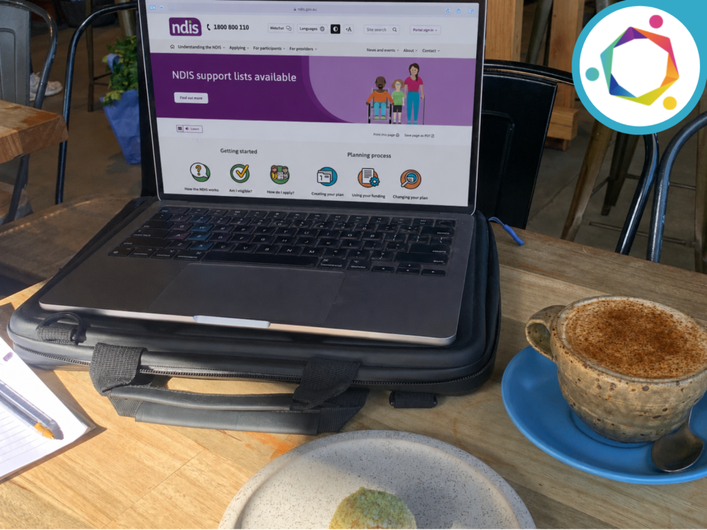 Photo of laptop at a cafe showing the NDIS webpage.